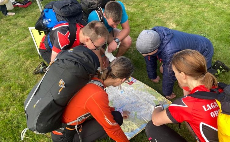 People with rucksacks on looking at a map for the Mourne Mountain Marathon