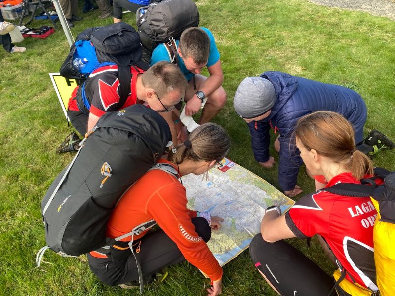 People with rucksacks on looking at a map for the Mourne Mountain Marathon